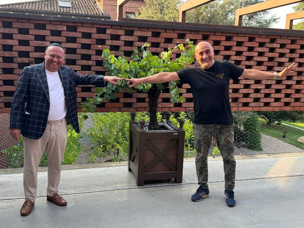 Dr. Ralph Madeb in the vineyard with a winemaker
